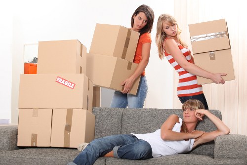 A neatly prepared moving room with labeled boxes and packing materials