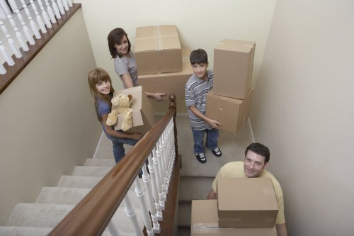 Professional movers unloading furniture into a Dulwich apartment